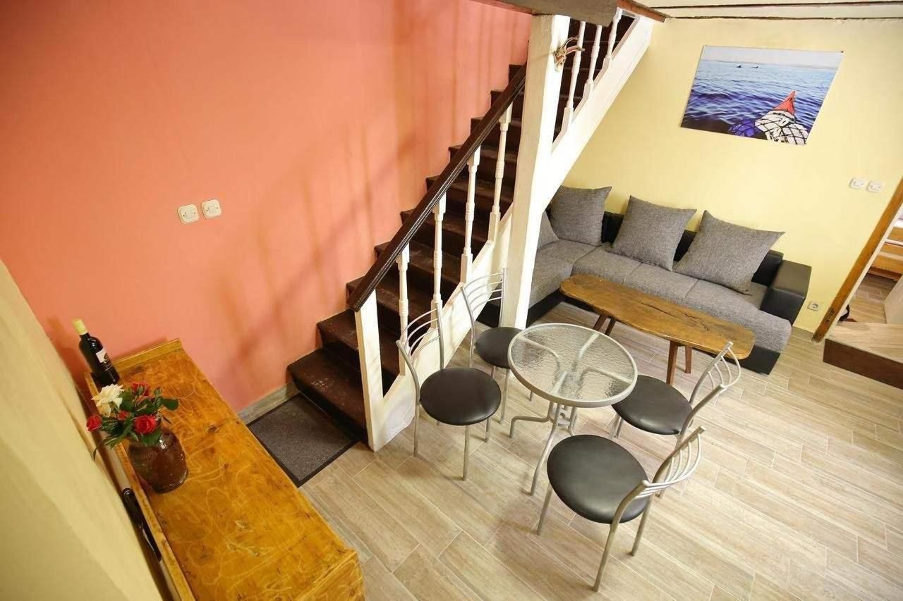 A living area with a sofa, a coffee table, and a staircase.