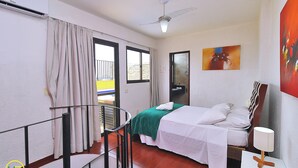 A hotel room with a bed, a nightstand, a chair, a ceiling fan, and a window with curtains. - MZapartments Raul Penthouse 06 (Rio de Janeiro)