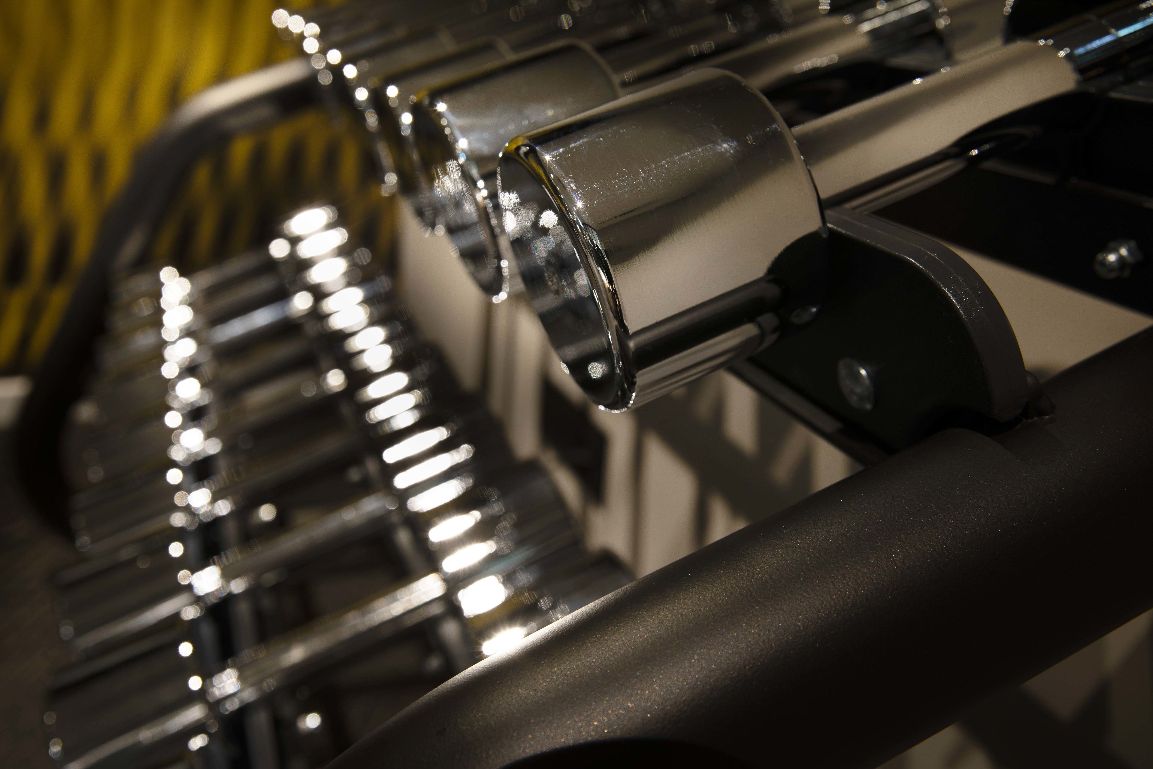 A close-up of a mechanical device with metallic components and reflective surfaces.
