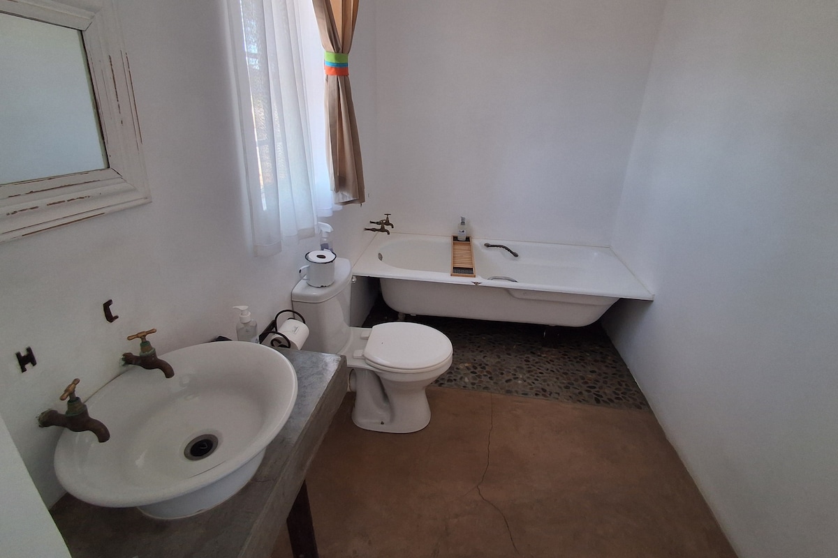 A small bathroom with a sink, toilet, and bathtub.