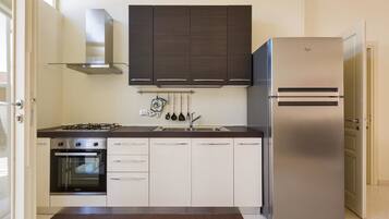 Comfort Apartment, 2 Bedrooms | Private kitchen | Full-sized fridge, oven, stovetop, cookware/dishes/utensils