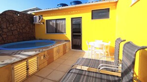 A yellow building with a swimming pool, outdoor seating, and a stone wall. - MZapartments Raul Penthouse 03 (Rio de Janeiro)