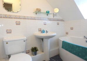 A bathroom with a toilet, sink, and bathtub. - Grove House (Gosport)