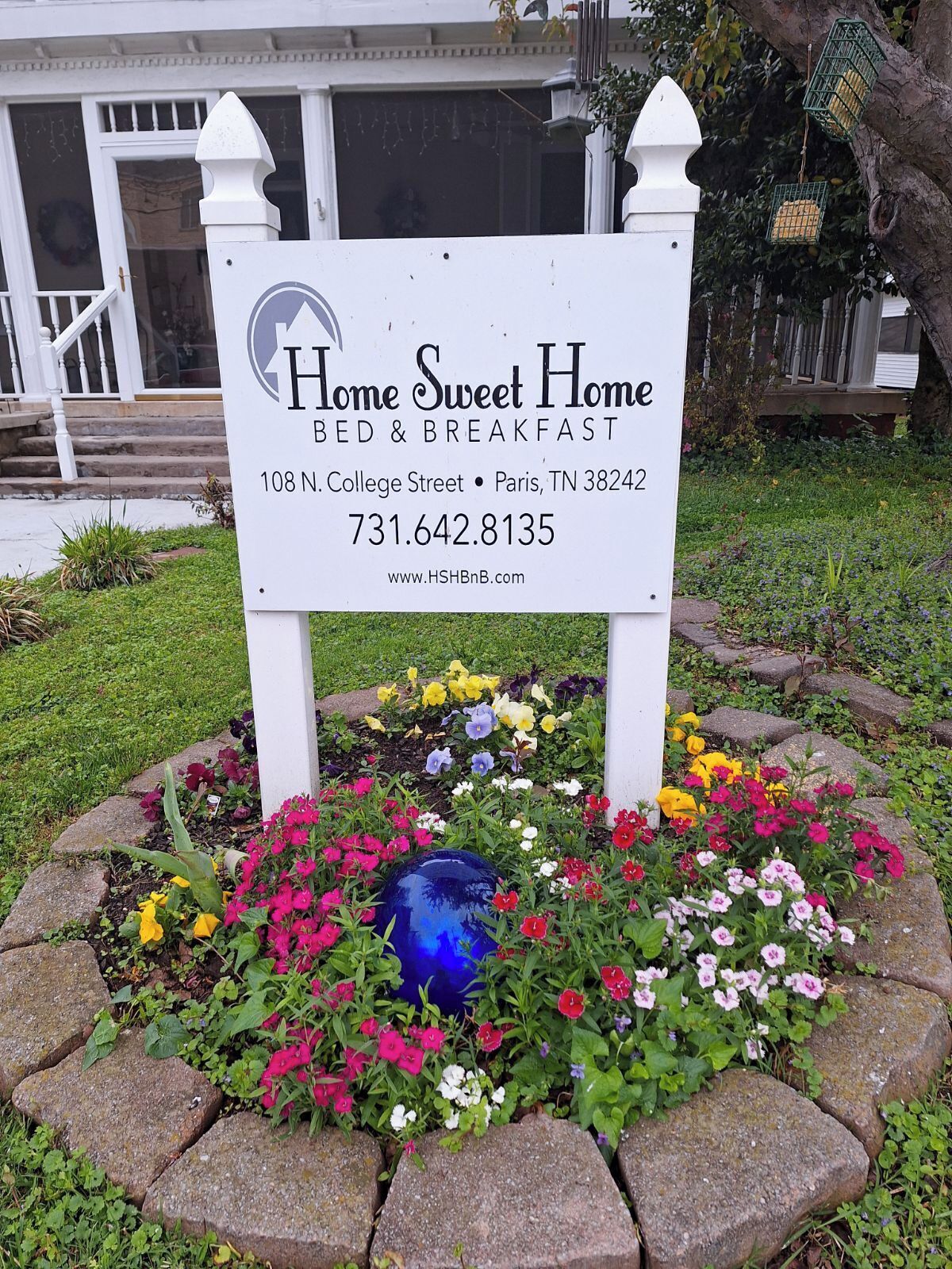 A sign for Home Sweet Home Bed & Breakfast with contact details and a website URL.