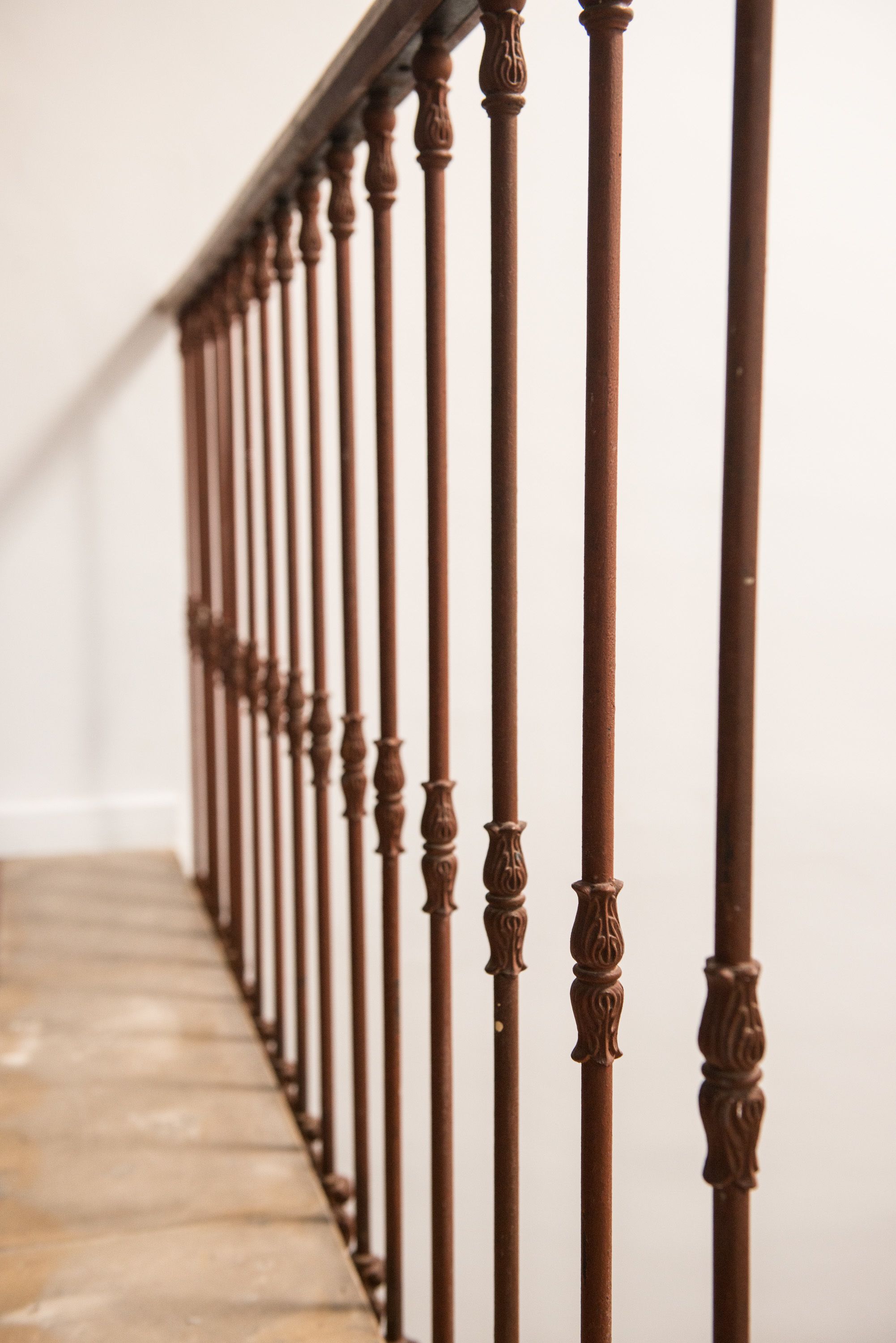 A wooden staircase with ornate balusters.