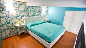 A bedroom with a bed, nightstand, and wardrobe. - B&B Mary Flower (Naples)