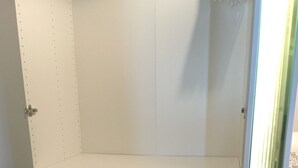 A white, empty shelving unit with four shelves and a door. - Newstyle (Regensburg)