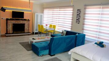 Apartment, Non Smoking | Living area | LCD TV, fireplace