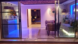 A hotel entrance with a neon sign reading "HOTEL HAXACTUN". - Hotel Yaxactun (Progreso)