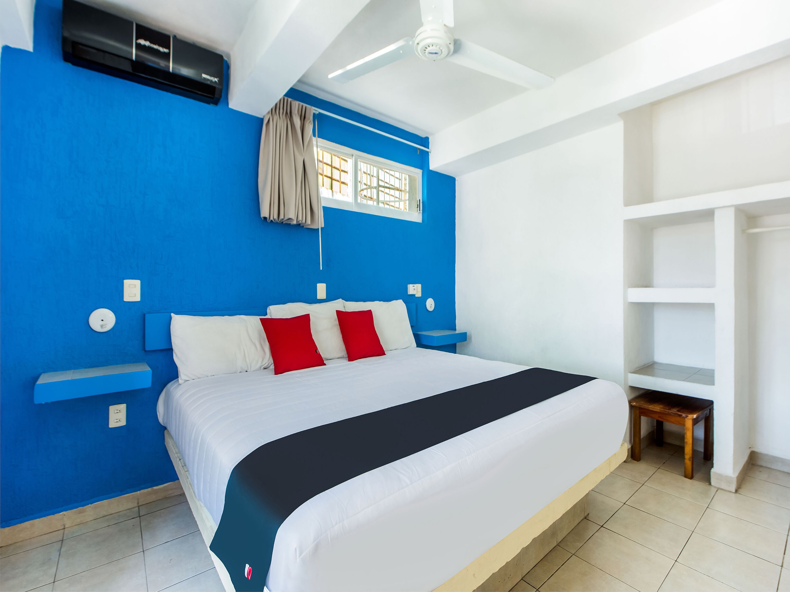 A bedroom with a bed, a window, and a ceiling fan.