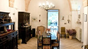 Un coin repas agrémenté d’un lustre, d’un buffet en bois et d’une table dressée pour quatre personnes.
