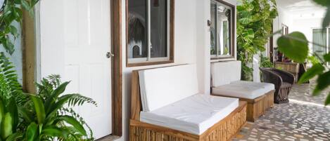 A room with a bed, a door, and a window.
