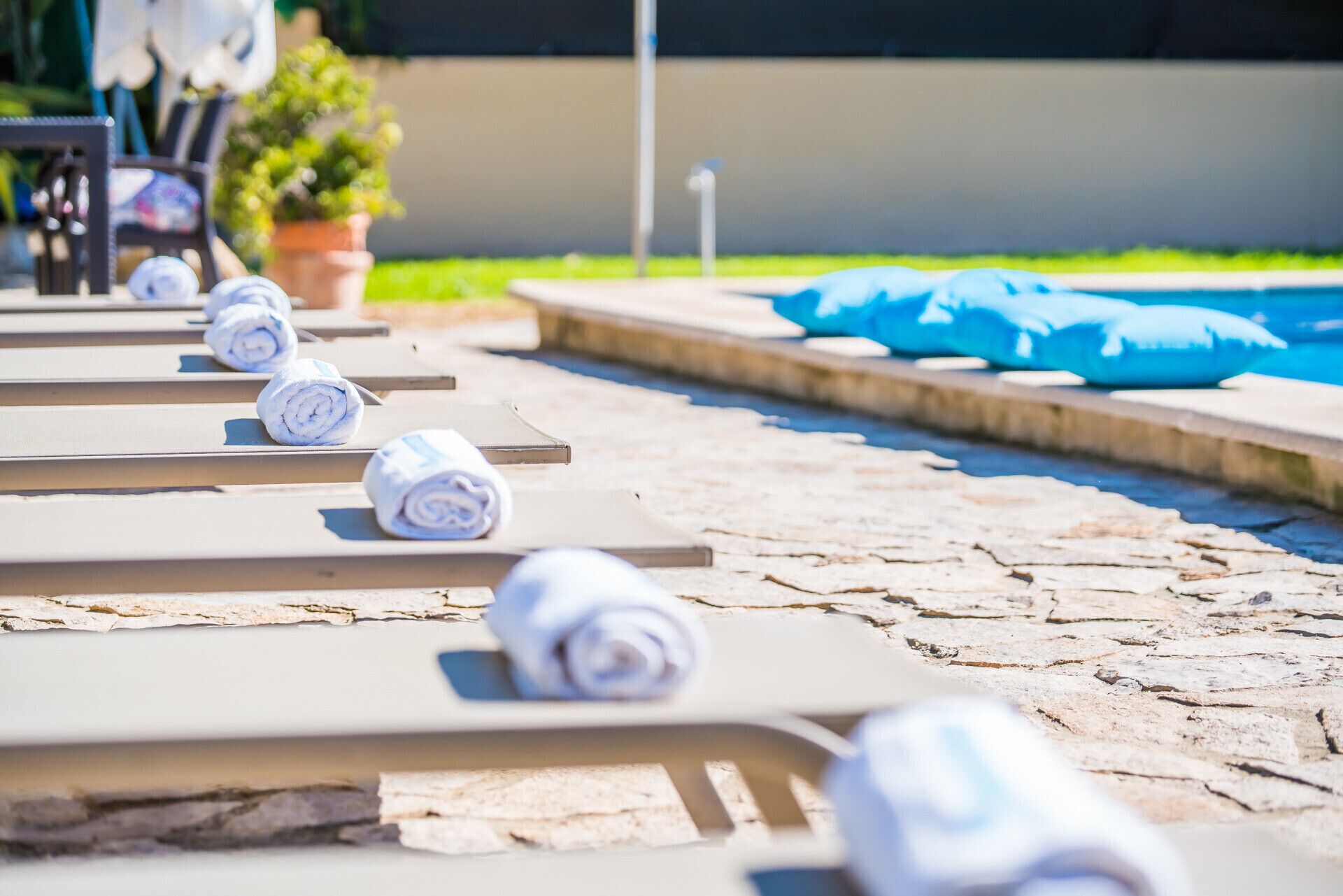 A poolside area with lounge chairs and towels.