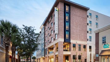 A multi-story hotel with a brick facade, large windows, and a prominent sign reading "HYATT PLACE".
