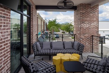 A multi-story hotel with a modern design, featuring large windows and a flat roof. at Hyatt Place Mount Pleasant Towne Centre