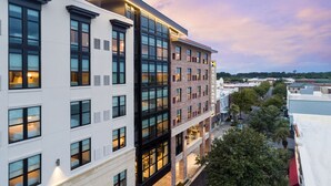 A multi-story hotel with a modern design, featuring large windows and a flat roof. - Hyatt Place Mount Pleasant Towne Centre (Mount Pleasant)