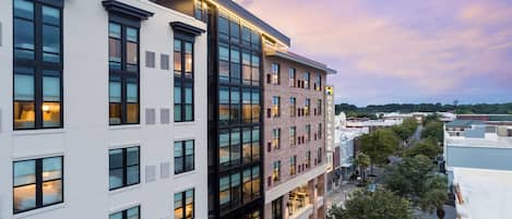 A multi-story hotel with a modern design, featuring large windows and a flat roof.