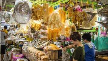 A market stall with various food items hanging and displayed.