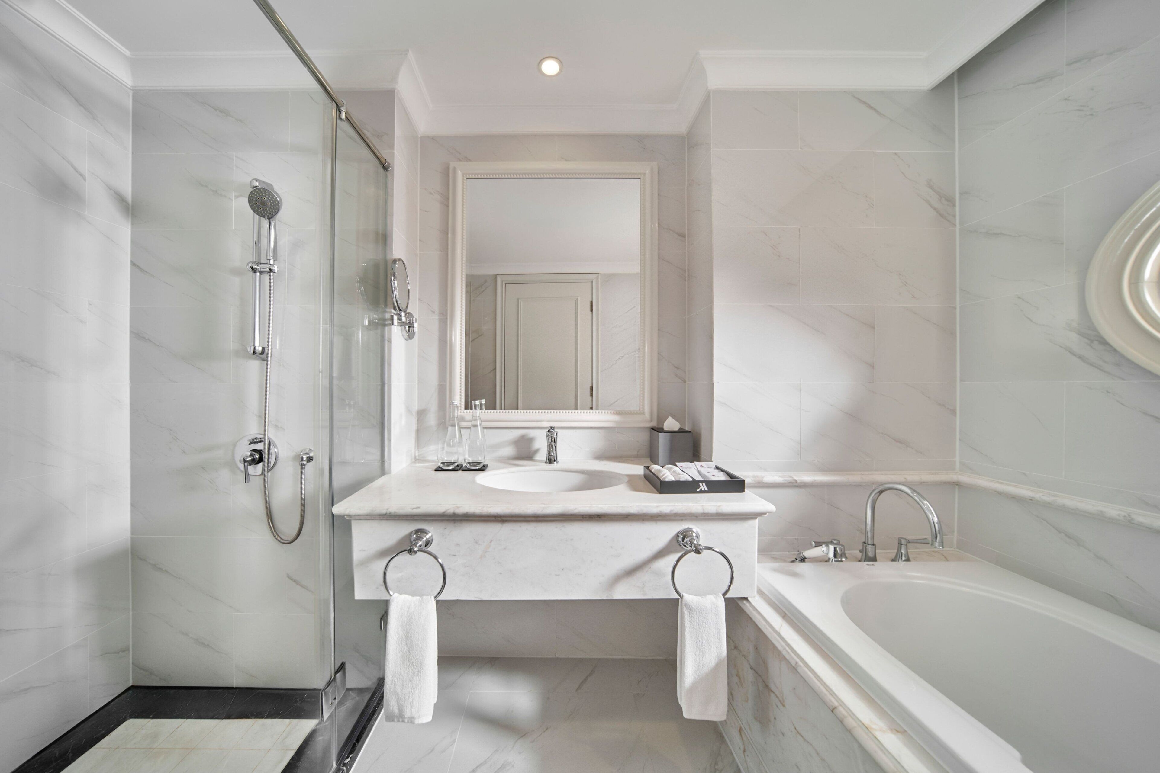 A modern bathroom with a large bathtub, a separate shower area, and a double sink vanity.
