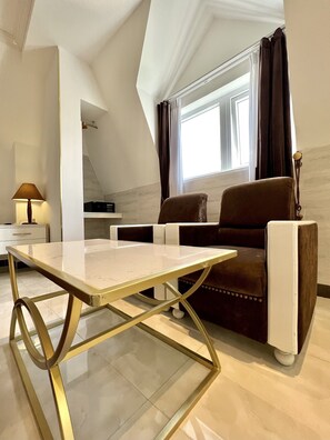 Suite Quadruple Room | Living area | 40-inch LCD TV with cable channels, TV