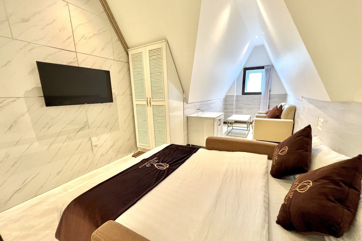 Kamar Quadruple Premium | Minibar, brankas, meja kerja, dan tirai kedap cahaya