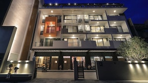 A multi-story building with a modern design, featuring balconies and large windows. - Peach Blossom (Taitung)