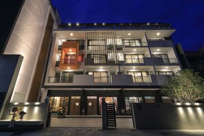 A multi-story building with a modern design, featuring balconies and large windows. - Peach Blossom (Taitung)