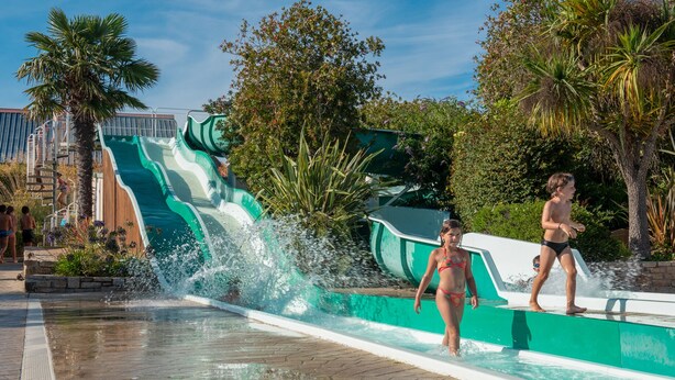 A water park with a large water slide and a pool area.