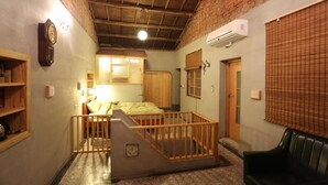A room with a bunk bed, wooden railing, brick walls, and an air conditioning unit. - Loku.Tainan (Tainan)