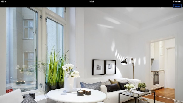 A modern living room with a white sofa, a round coffee table, and a large window. - Apt. Odins Gate (Oslo)