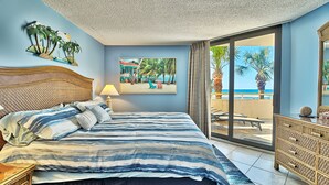 A bedroom with a bed, a dresser, a painting, and a view of the beach. -  Label Day Weekend Now Available 1st Floor-XXL Oceanfront Balcony OC Tower South (Myrtle Beach)