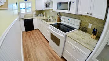 Fridge, microwave, coffee/tea maker, cookware/dishes/utensils