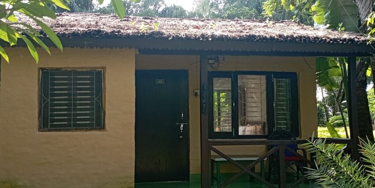 A small, single-story building with a tiled roof and a door marked with the number 101.
