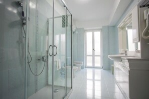 A modern bathroom with a glass shower enclosure, a white toilet, and a sink area. - Hotel San Marco (Rionero in Vulture)