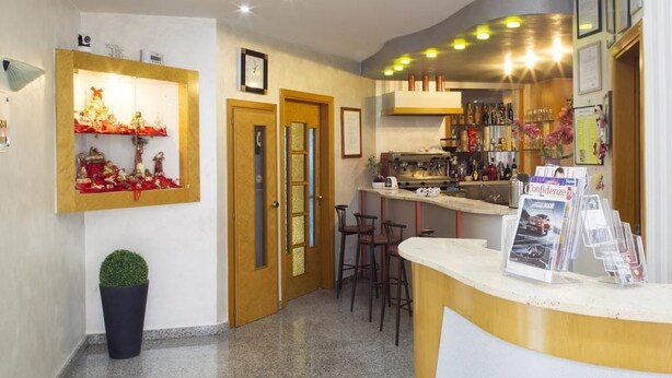 A reception area with a counter, bar, and display of Christmas decorations. - Hotel San Marco (Rionero in Vulture)