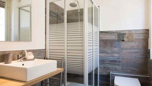 A modern bathroom with a large white sink, a glass shower enclosure, and a white toilet. - B&b Zammù (Palermo)
