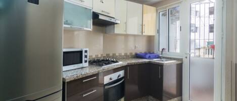 Apartment, 2 Bedrooms | Private kitchen | Fridge, oven, stovetop, cookware/dishes/utensils