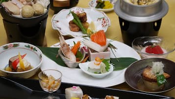 A variety of dishes on a tray, including seafood, vegetables, and other foods.