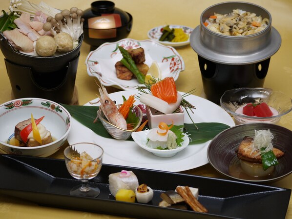 A variety of dishes on a tray, including seafood, vegetables, and other foods.