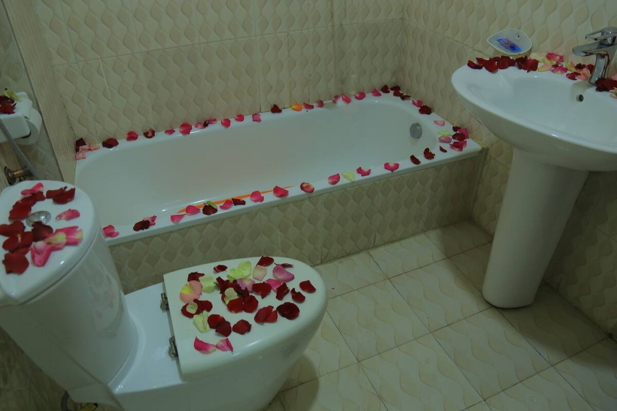 A bathroom with a bathtub, toilet, and sink.