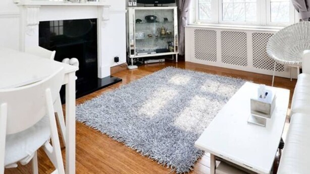A modern living room with a fireplace, a television, and a dining area. - Stylish 2 Bed Between Camden Town & Primrose Hill (London)