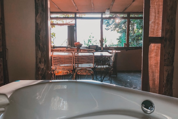 Whirlpool bathtub view toward picture windows