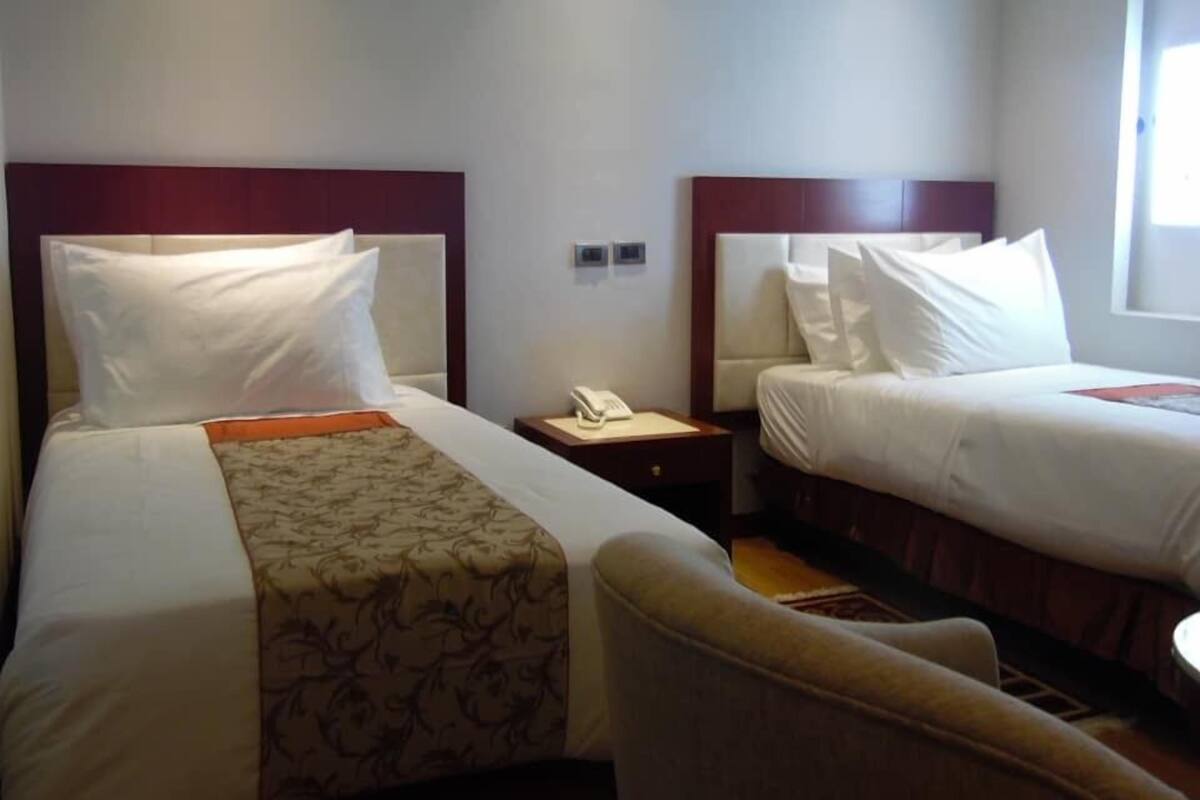 Twin Room | Minibar, in-room safe, desk, iron/ironing board (on request)
