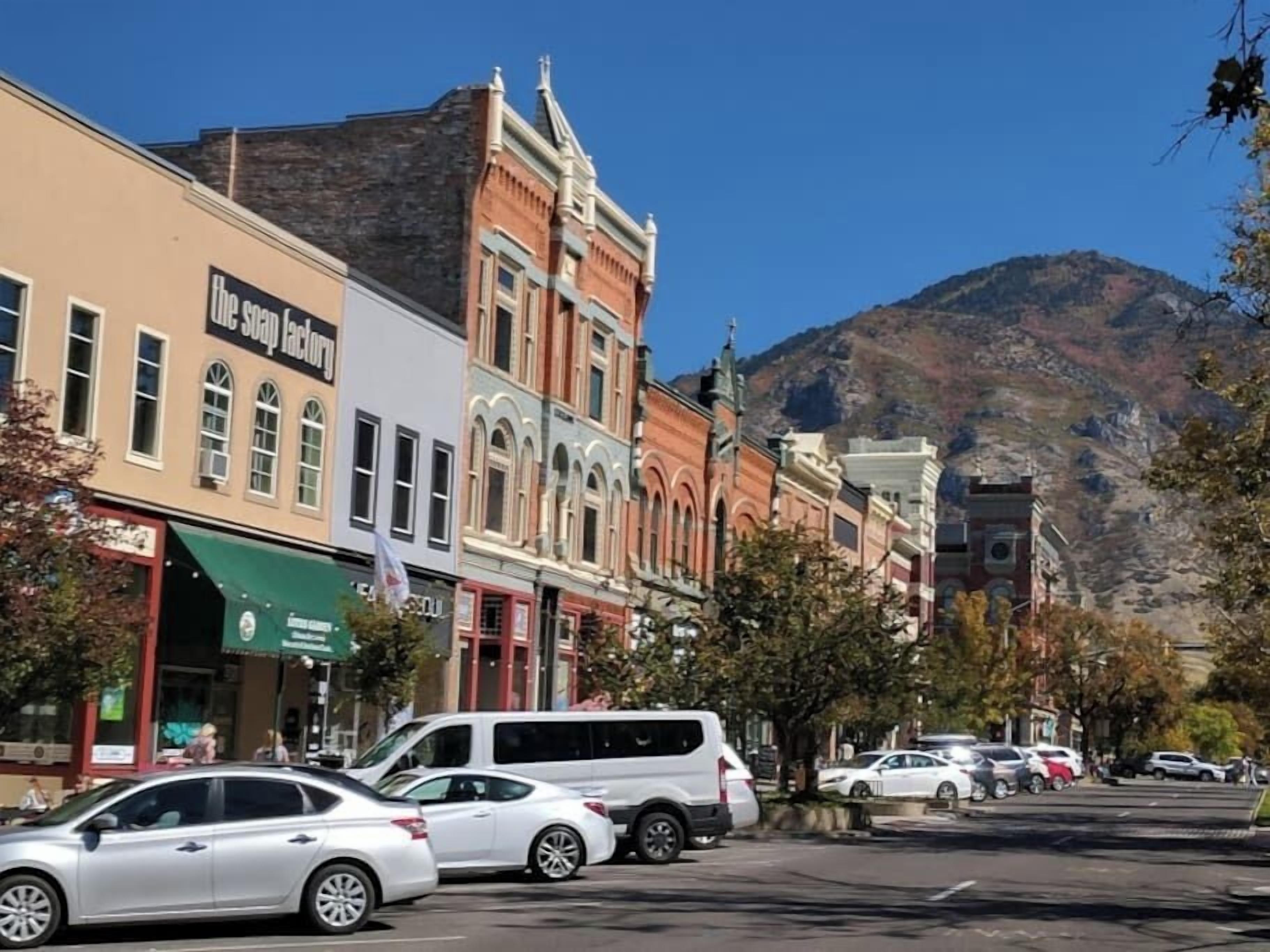 A street lined with historic buildings, including a shop named "the soap factory."
