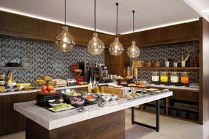 A modern kitchen with a marble countertop, wooden cabinets, and a herringbone tile backsplash. - Fairfield by Marriott Taichung (Taichung)