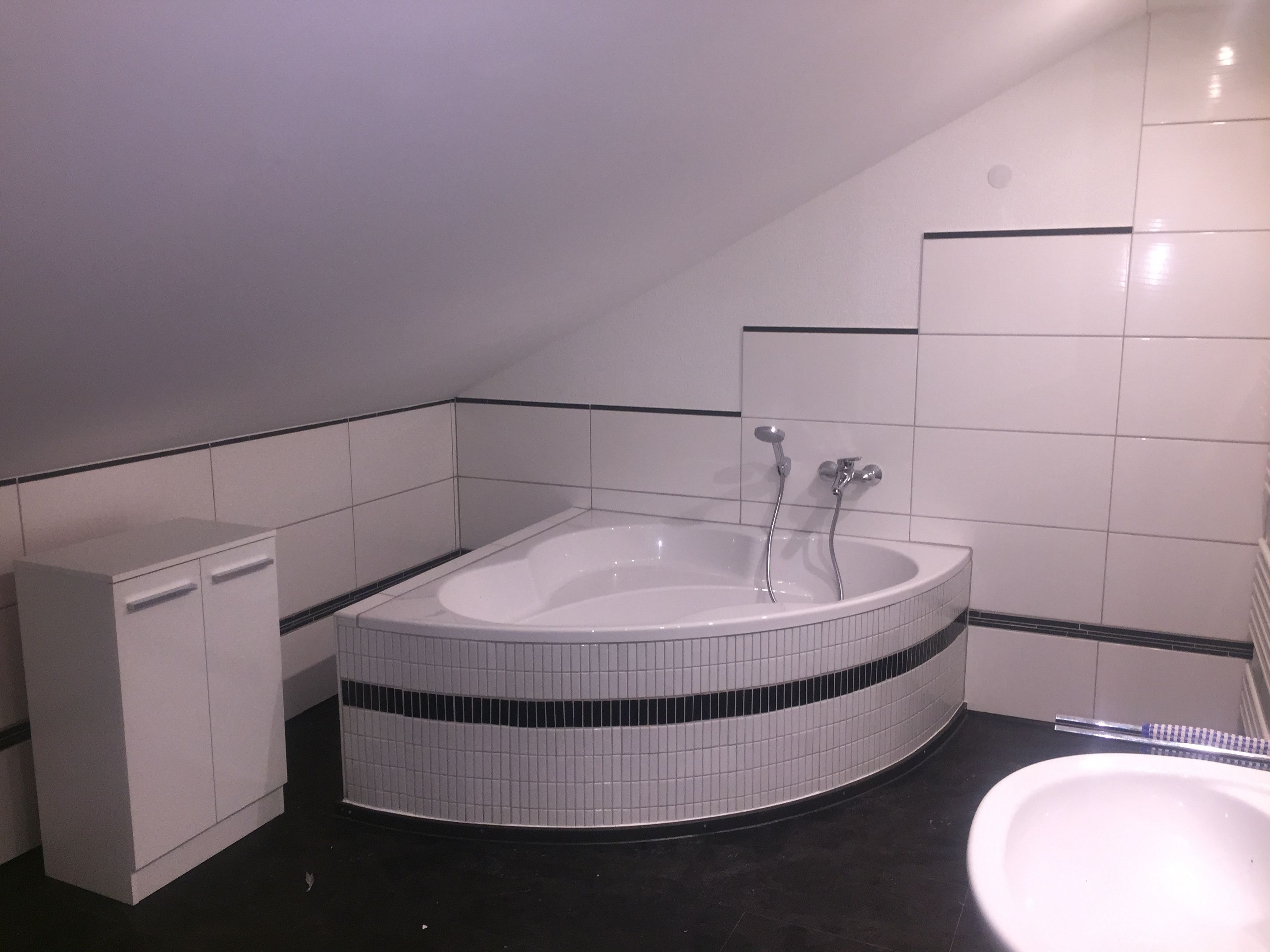 A bathroom with a freestanding bathtub, a toilet, and a sink.