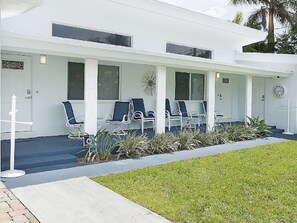 A modern building with a covered waiting area featuring several chairs and a clock on the wall. - BEACHFRONT, OCEAN! 2 BEDRMS, 3 BATHRMS, Discounts for longer stay APP-VRR1500402 (Fort Lauderdale)