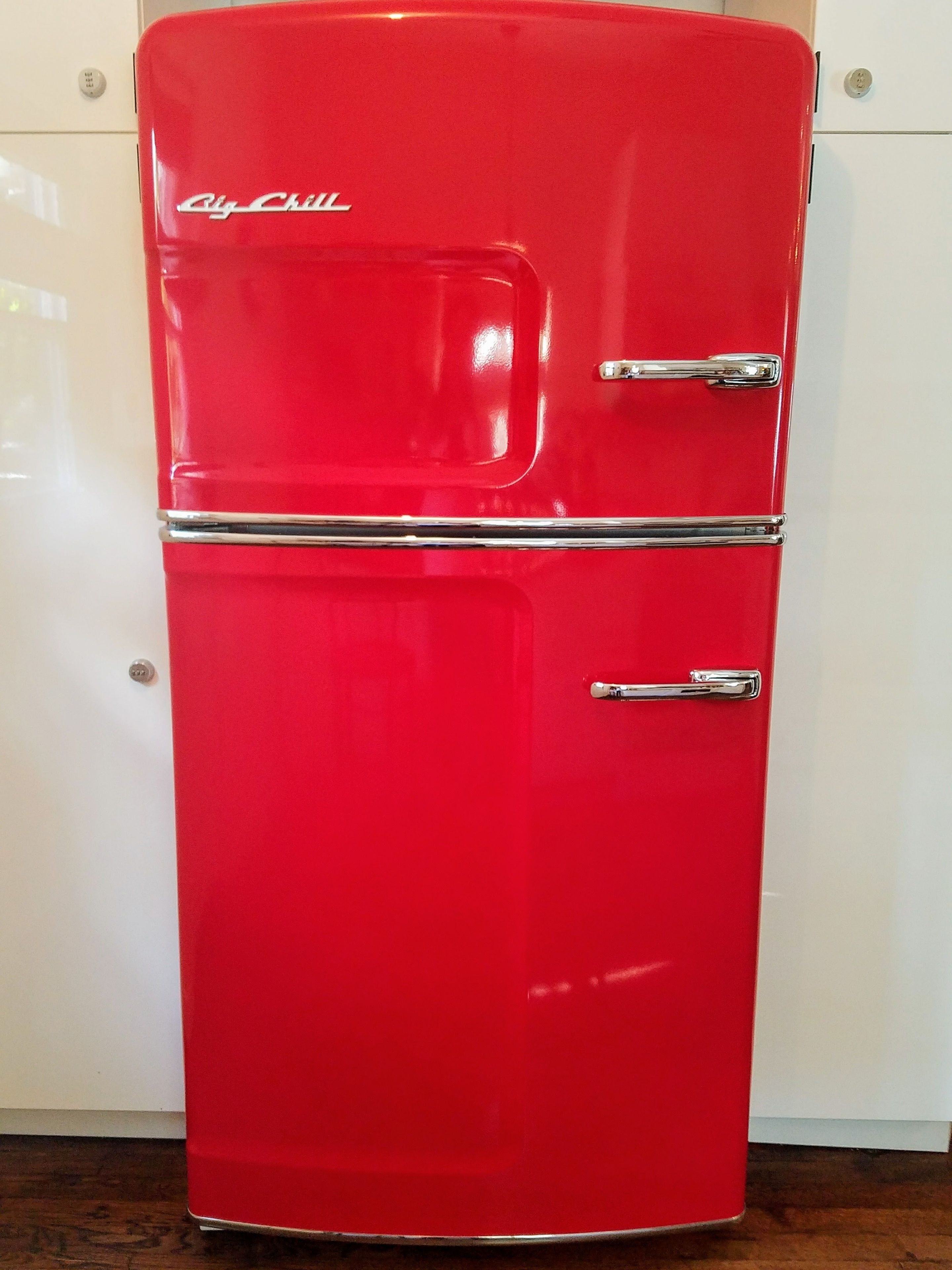 A red refrigerator with two doors and a freezer compartment, labeled "City Chill."