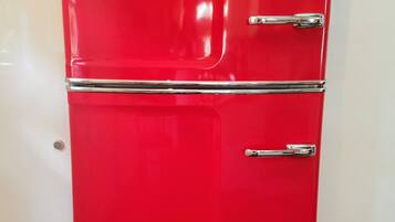 A red refrigerator with two doors and a freezer compartment, labeled "City Chill."