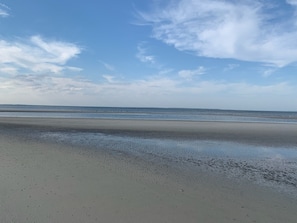 A beach with a wide sandy shore and gentle waves. - Beautiful, Easy Ocean Access (Hilton Head)